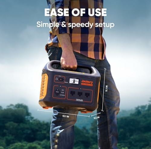 Person holding a portable power station outdoors.